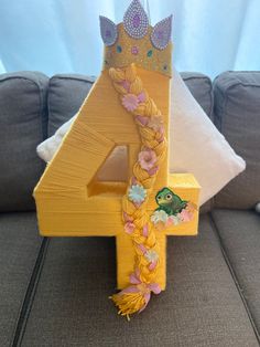 the number four is decorated with flowers and a crown