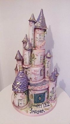 a birthday cake that is shaped like a princess's castle with the words happy birthday written on it