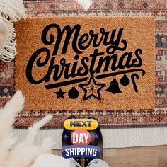 a door mat with the words merry christmas next to it