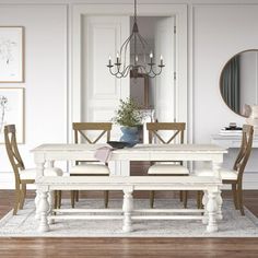 a dining room with white walls and wooden floors