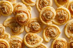 small pastries are arranged on a white surface