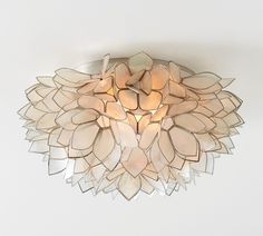 a light that is on the ceiling in a room with white walls and flooring