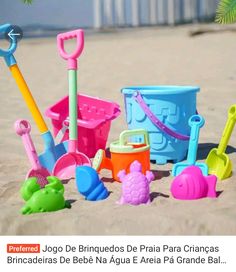 there are many toys in the sand and one is pink, blue, yellow or green