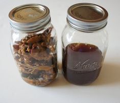 two jars filled with food sitting next to each other