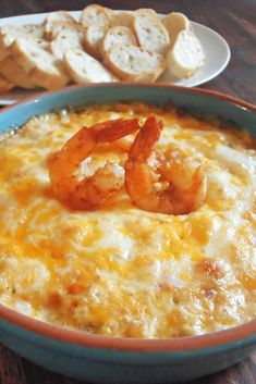 a bowl of shrimp dip with bread on the side