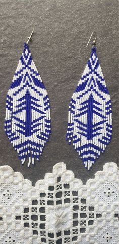 White Handwoven Beaded Dangle Earrings, White Handwoven Dangle Beaded Earrings, Artisan White Beaded Earrings With Dangling Beads, White Handwoven Drop Earrings, Traditional Handwoven Blue Beaded Earrings, Traditional Blue Handwoven Beaded Earrings, Elegant White Handwoven Earrings, Artisan White Beaded Earrings With Colorful Beads, White Artisan Beaded Earrings With Colorful Beads