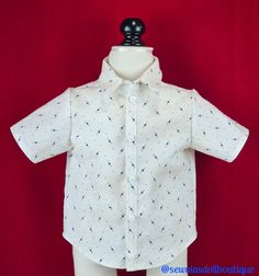 a white shirt with blue stars on it is sitting on a mannequin's head