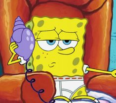 the spongebob character is holding a balloon in his hand while sitting on a chair