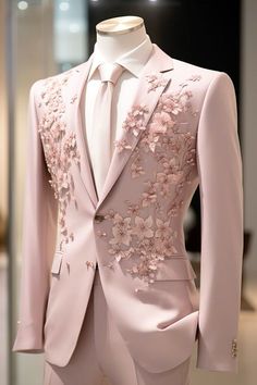 a pink suit with flowers on it is displayed in front of a mannequin