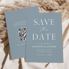 two save the dates cards sitting on top of a white sheet with a brown fur