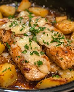 chicken, potatoes and gravy in a crock pot with parsley on top