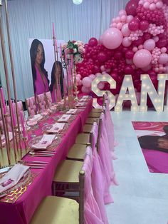 a long table with pink and gold decorations