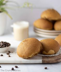 buns on a cutting board with chocolate chips next to them