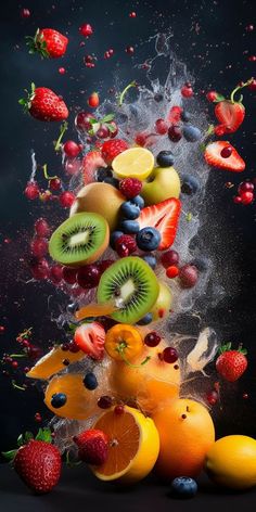 fruit falling into the air with splashing water on them and strawberries, kiwis, oranges, lemons, raspberries