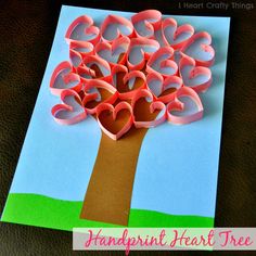 a paper tree with hearts cut out of it on top of a piece of paper