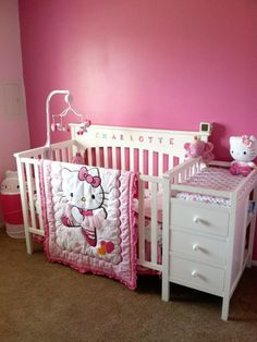 a hello kitty crib bedding set in a pink room with white dressers