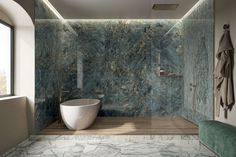 a bathroom with marble walls and flooring, along with a bathtub in the middle