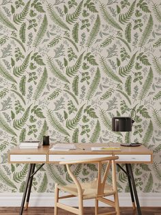 a desk with a lamp on it next to a plant wallpaper