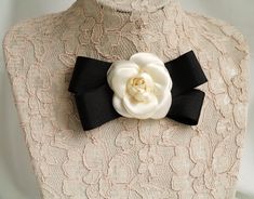 Women bow tie with black stripped ribbon and handmade silk camellia flower in cream white color Beautiful gift for girlfriend, women, wife, mother or daughter on Christmas or any other occasion. This handmade bow tie can be worn on a shirt, a dress, a sweater, a t-shirt or as an accessory for coat, bag or everything is allowed to be attached by a brooch. My Flower accessories are Individually sculpted using a mix between French & Japanese techniques. The construction of each flower starts as Formal White Brooch With Bow, Formal White Bow Brooches, Formal White Bow Brooch, Classic Bow Brooch For Gift, Classic Bow Brooches For Gift, Classic Bow Brooch As Gift, Classic Wedding Brooch With Bow, Elegant Bow Lapel Pin For Weddings, Elegant Rosette Brooches As A Gift