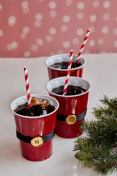 three red cups filled with drinks sitting on top of a table