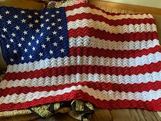 an american flag crocheted afghan on a couch