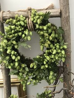 a wreath with green flowers hanging on a wall