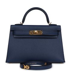 This Kelly, in the Sellier style, is in Bleu Navy epsom leather with gold hardware and has tonal stitching, two straps with front toggle closure, single rolled handle and removable shoulder strap.The interior is lined with Bleu Navy lambskin leather and has one open pocket on the back wall. Collection: BOrigin: FranceCondition: New and never worn (plastic on hardware)Accompanied by: Hermes box, Hermes dustbag, shoulder strap, shoulder strap dustbag, felt, carebookMeasurements: 7.5" width x 4.5" Navy Kelly Bag, Blue Mini Kelly, Launer London, Elegant Blue Box Bag With Gold-tone Hardware, Luxury Navy Bags With Gold-tone Hardware, Hermes Constance Bag Blue, Hermes Box, Kelly Bag, Handbag Wallet