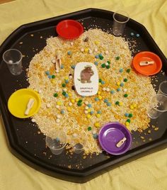 a tray filled with lots of food on top of a yellow tablecloth covered floor