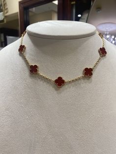 This stunning Van Cleef & Arpels Alhambra necklace features 10 delicate motifs made of 18k yellow gold and adorned with Carnelian stones. The intricate chain style creates a timeless and elegant look that is perfect for any occasion. The piece is part of the Van Cleef & Arpels collection, and the brand's attention to detail is evident in the exquisite craftsmanship of each motif. Ideal for jewelry collectors and those who appreciate fine jewelry, this necklace is a must-have addition to any jewelry collection. Luxury Brands Jewelry, Red Van Cleef Necklace, Vanclif Neckles, Van Cleef Arpels Alhambra Necklace, Van Cleef Necklace, Alhambra Necklace, Designer Things, Red Vans, Xmas List