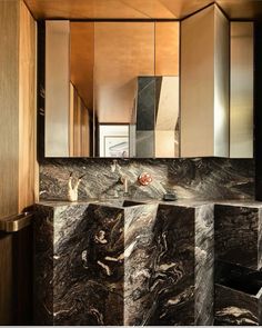 a bathroom with marble counter tops and cabinets