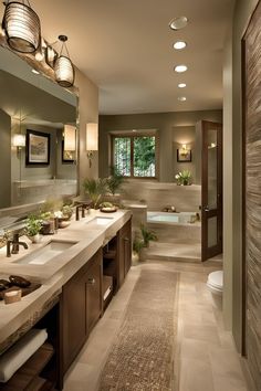 a large bathroom with two sinks, mirrors and lights on the ceiling is shown in this image