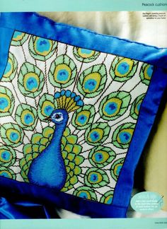 a blue and green pillow with a peacock on it