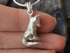 This unique, three dimensional wolf pendant is cast in solid sterling silver. I sculpted this wolf in my home studio on the beautiful Gold Coast of Australia.  My sculpting journey began many years ago when I started working with polymer clay. I developed a love for this medium because I could make intricate, small sculptures, mould, and cast them into sterling silver jewellery. All my pieces are completely original, handmade creations. You can see the original sculpture in the last photo. If you are fascinated by Wolves or find yourself drawn to them, you are not alone. On the one hand Wolves can represent chaos and destruction, while they're also known to represent bravery, loyalty, protection, and wisdom.  Wolves are complex, highly intelligent animals who are playful, caring, and above Wolf Jewelry Necklaces, Wolf Pendant, Wolves Pendants, Wolf Necklace, Wolf Jewelry, Silver Wolf, Small Sculptures, Sterling Silver Jewellery, Small Pendant