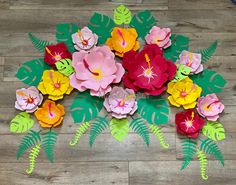 paper flowers are arranged on a wooden floor