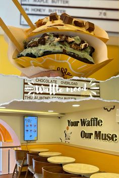 the inside of a fast food restaurant with chairs and tables in front of an advertisement on the wall