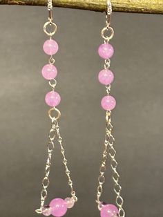 These are a pair of beautifully handmade one of a kind lavender and purple amethyst chandelier earrings. These hang from sterling silver chains in a triangular shape. They close with sterling silver lever backs. These earrings are minimalist designed.  The lavender amethyst earrings measurement is 4 inches long including the lever back earring wire. The lavender color is a soft lavender color, great gift. Pink Sterling Silver Chandelier Earrings As A Gift, Lavender Dangle Jewelry For Party, Lavender Dangling Beads For Jewelry Making, Lavender Dangle Earrings With Ear Wire, Lavender Sterling Silver Dangle Jewelry, Lavender Dangle Jewelry With Dangling Beads, Lavender Adjustable Dangle Beaded Earrings, Purple Metal Dangle Chandelier Earrings, Purple Wire Wrapped Chandelier Drop Earrings