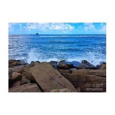 the ocean with rocks and waves crashing in to shore