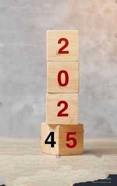 a wooden block with numbers on it sitting in front of a gray background that says 2012