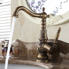 a faucet that is sitting on top of a sink with water running from it