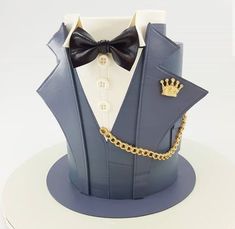 a cake made to look like a tuxedo with a crown on his chest