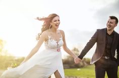 a man and woman are holding hands in the grass