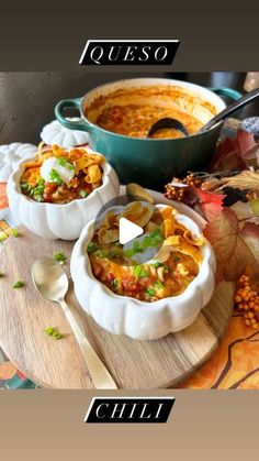 two bowls of soup sitting on top of a wooden table