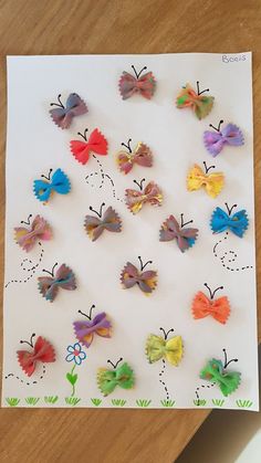 paper butterflies are arranged on a sheet of paper