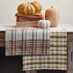 pumpkins and gourds are sitting on a table