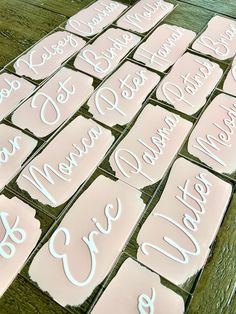 some cut out cookies that are on top of a wooden table with white frosting