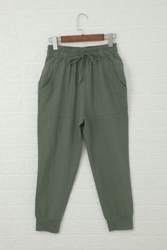 Green Causal Pockets Pants Casual High Waist Capris With Pockets, Casual High-waist Capris With Pockets, Casual Capris With Pockets For Loungewear, Casual Khaki Cotton Capris, Khaki Lounge Bottoms With Pockets, Khaki Bottoms With Pockets For Loungewear, Summer Sweatpants With Pockets And Tapered Leg, Khaki Loungewear Bottoms With Pockets, Khaki High-waisted Casual Pants