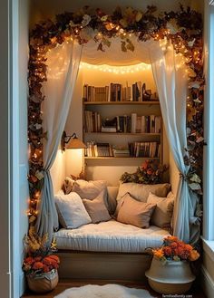 a room with a couch, bookshelf and some lights on the wall above it