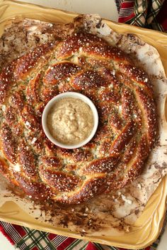 an assortment of breads and dipping sauce on a platter