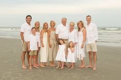 a family poses for a photo on the beach