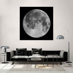 a living room filled with furniture and a large moon on the wall above it's head